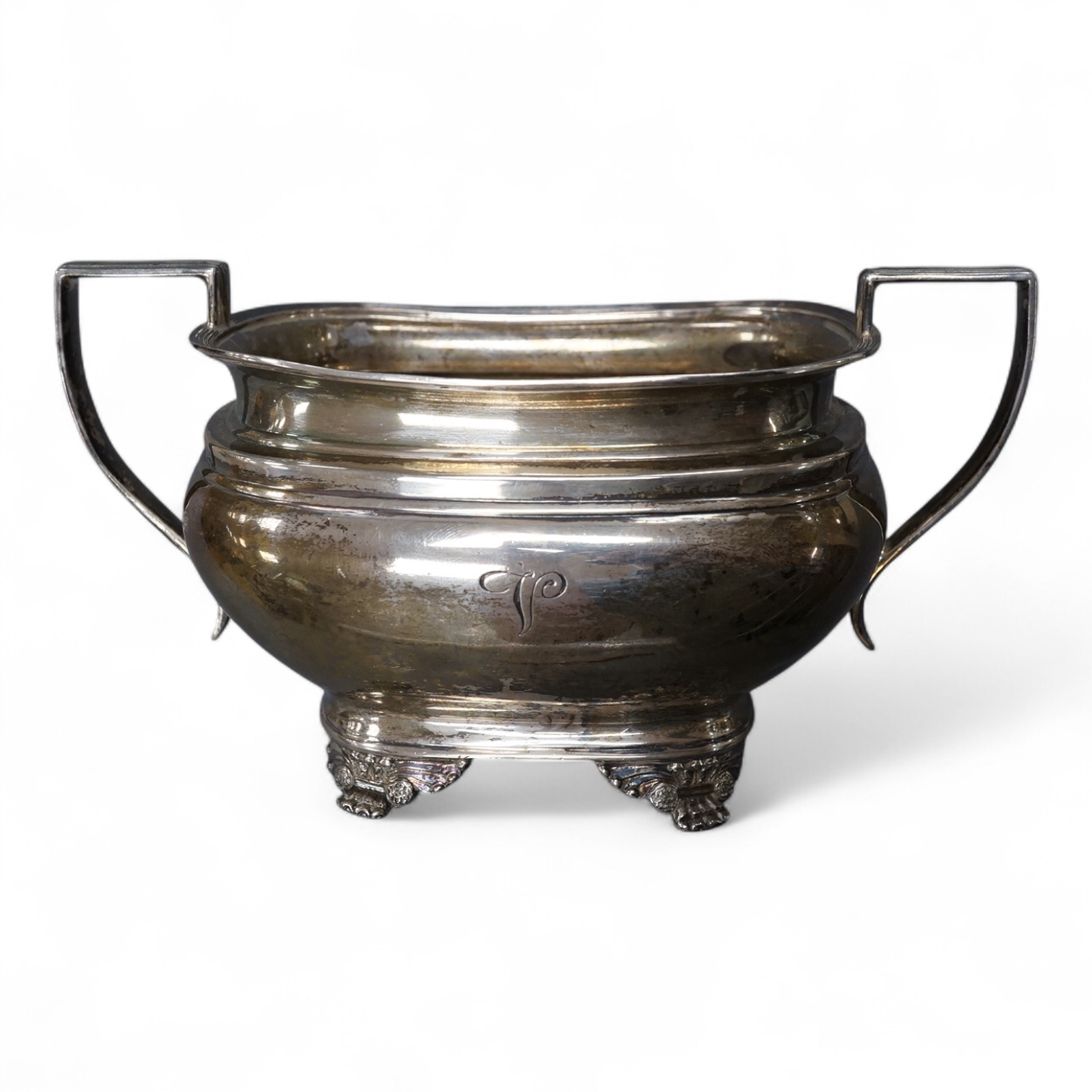 A George V silver two handled sugar bowl, by Goldsmiths & Silversmiths Co Ltd, Sheffield, 1923, with engraved initial, on four winged paw feet, length `7.1cm over handles, 8.5oz.